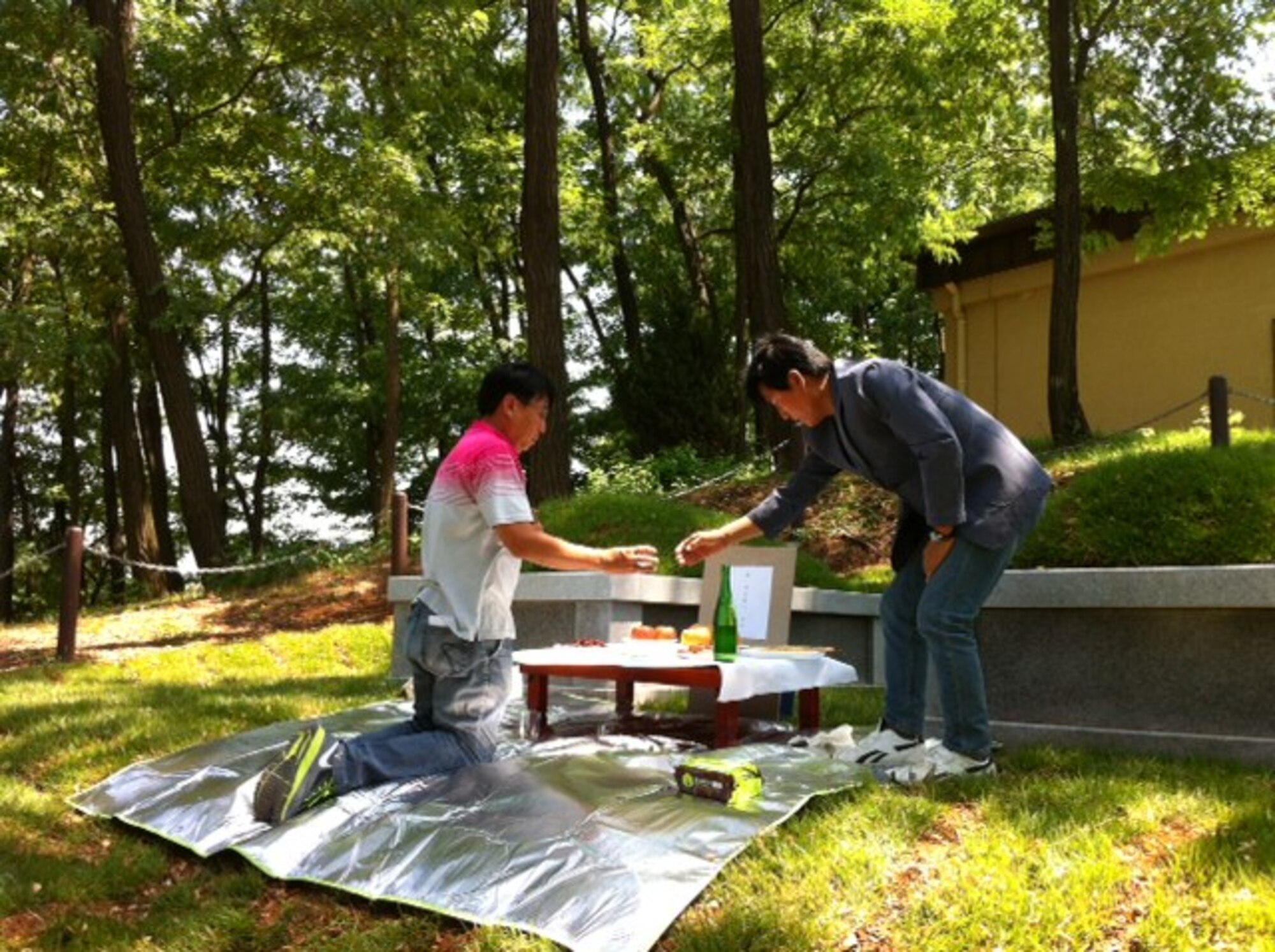 After renovating the gravesites, the environmental section performed an ancestral rites ceremony for the graves they renovated around. (Courtesy photo)