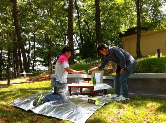After renovating the gravesites, the environmental section performed an ancestral rites ceremony for the graves they renovated around. (Courtesy photo)