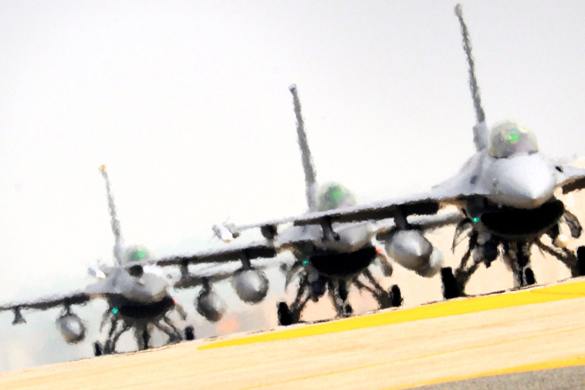 Three F-16 Fighting Falcons taxi onto the runway during exercise Beverly Midnight 14-2 at Kunsan Air Base, Republic of Korea, July 16, 2014. The Operational Readiness Exercise assesses mission capabilities and ensures the Wolf Pack is in a constant state of readiness. (U.S. Air Force photo by Senior Airman Taylor Curry/Released) 