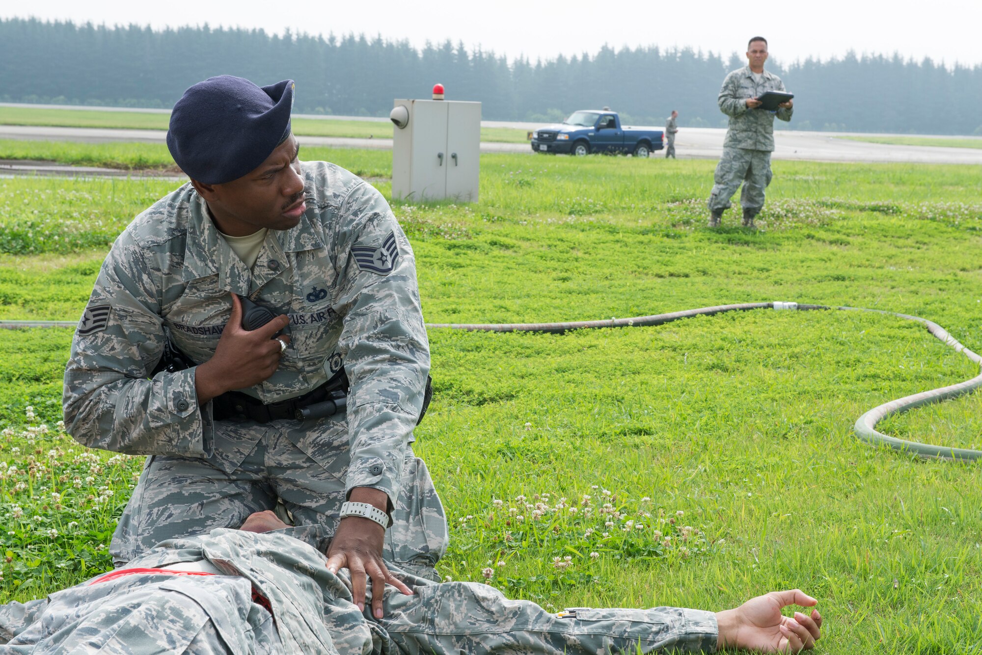 Staff Sgt. Louis Bradshaw, 374th Security Forces installation security, tends to a simulated casualty at the sight of a vehicle accident scene during an Emergency Management Exercise at Yokota Air Base, Japan, July 17.  The simulated accident featured a number of simulated casualties to test first responders’ abilities to react to the situation.  (U.S. Air Force photo by Tech. Sgt. Christopher Marasky)
