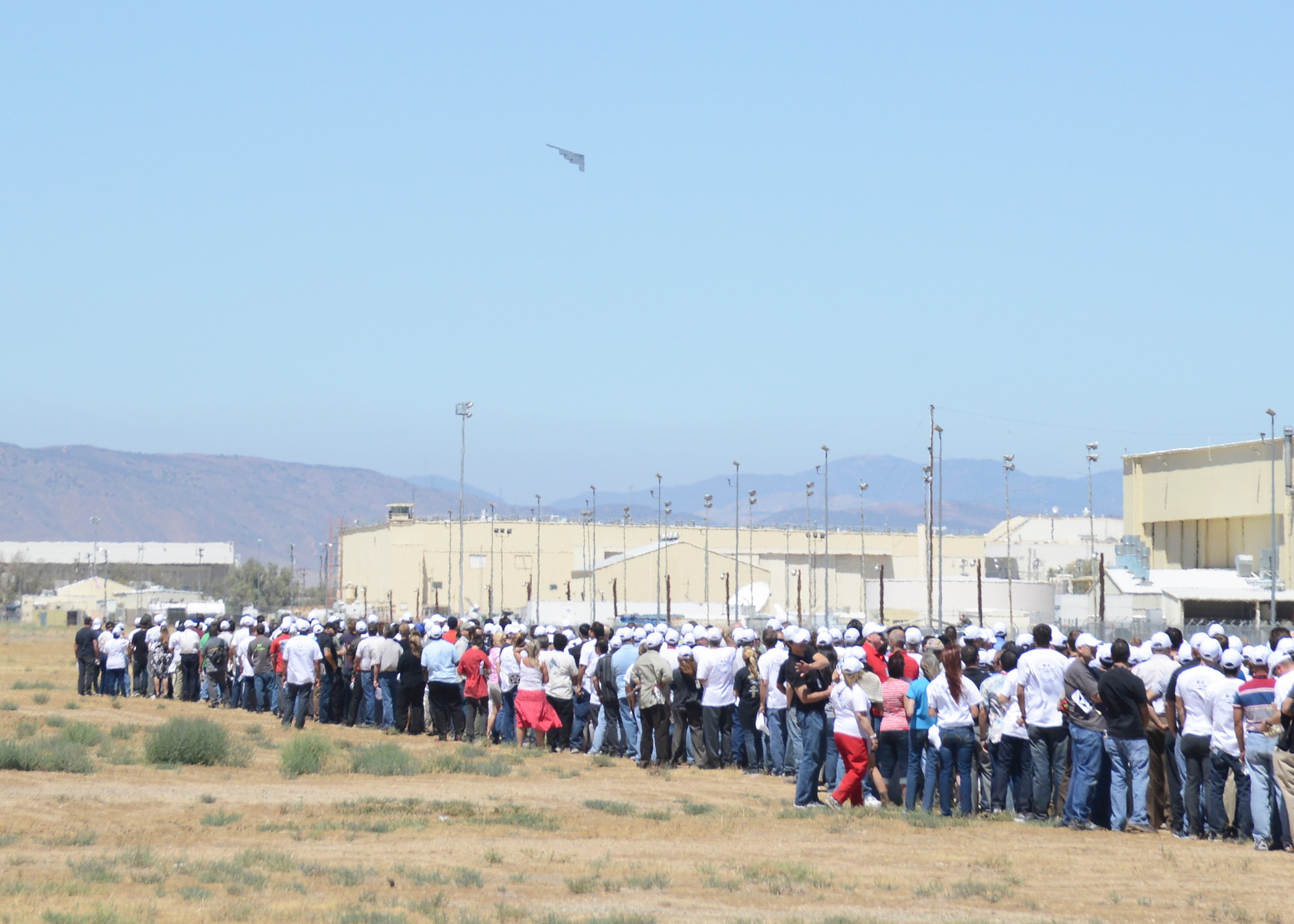 Crowds of Northrop Grumman employees, civic leaders and military personnel watch a B-2 Spirit take to the sky, reenacting the first takeoff of the B-2. (U.S. Air Force photo by Kenji Thuloweit)