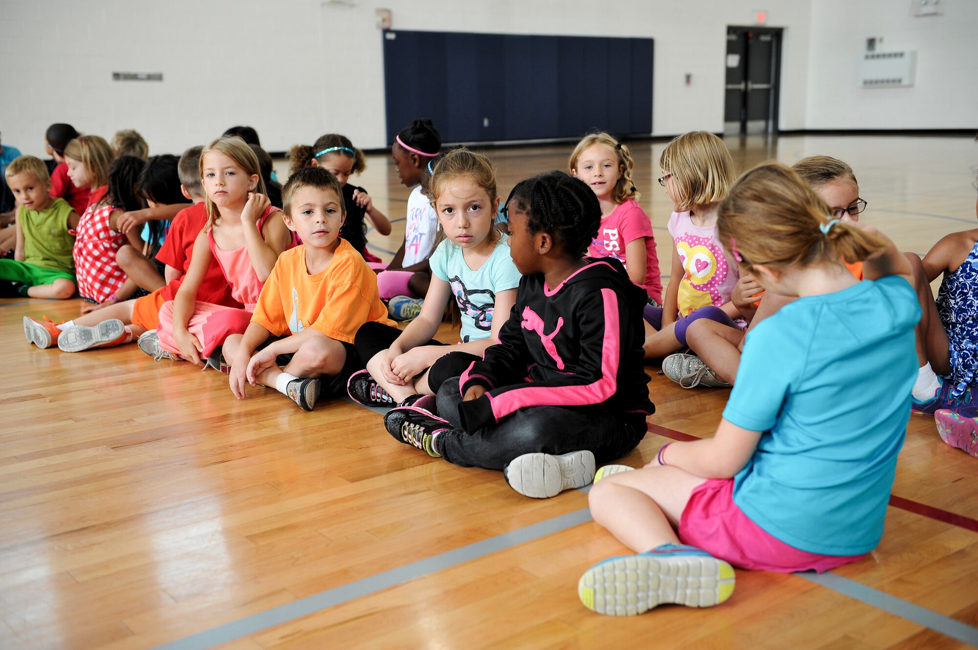Children from Buckley Air Force Base, Colo. sit patiently waiting for the Missoula Children’s Theater rehearsal to begin, July 16, 2014, at the youth center on base. This annual event requires the youth to practice for only four days to produce the play Blackbeard the Pirate. (U.S. Air Force photo by Senior Airman Phillip Houk/Released)