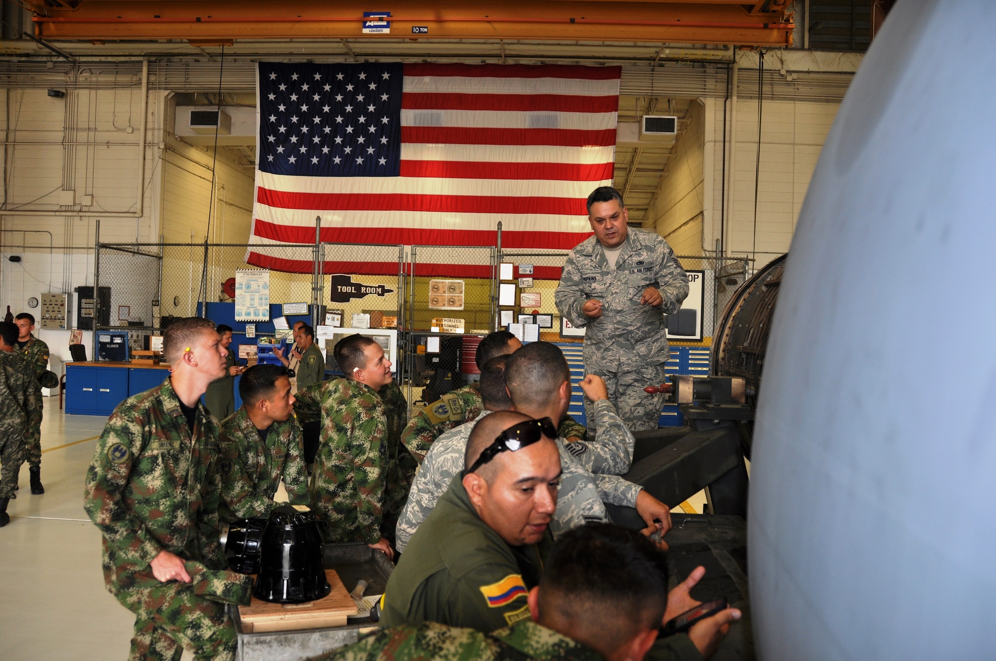 Senior Master Sgt. Albert Hopkins, jet engine mechanic, 433rd Maintenance Squadron, Joint Base San Antonio-Lackland, Texas explains the TF-39 jet engine to Inter-American Air Forces Academy students during a tour, July 17, 2014. The tour continued an Alamo Wing tradition of how "Alamo Wing" maintainers keep their inventory of C-5A Galaxies air worthy. (U.S. Air Force photo by Tech Sgt. Carlos J. Trevino)