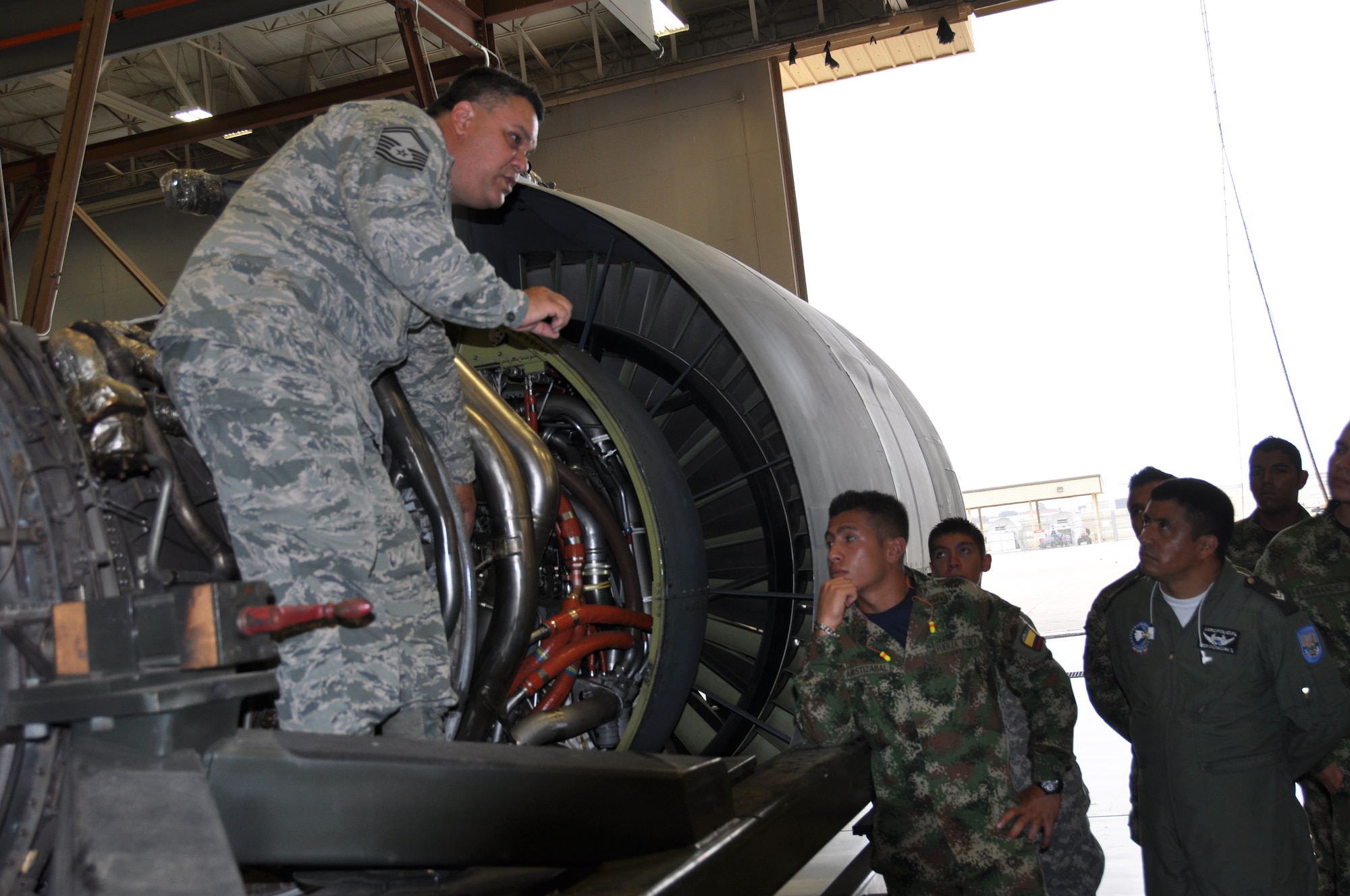 Senior Master Sgt. Albert Hopkins, jet engine mechanic with the 433 Maintenance Squadron, Joint Base San Antonio-Lackland, Texas explains the TF-39 jet engine to Inter-American Air Forces Academy students, also from JBSA-Lackland during a tour on July 17, 2014.The students received tour of a C-5A static, the wing's propulsion branch, the metals technology and structural repair shops, and how the “Alamo Wing” maintainer’s keep their C5As mission ready. (U.S. Air Force photo by Tech Sgt. Carlos J. Trevino)

