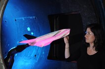 Inna Kurits, Arnold Engineering Development Complex (AEDC) Tunnel 9 test engineer, checks the Air Force HiFEX vehicle geometry for final readiness before being tested in the AEDC Hypervelocity Wind Tunnel 9.  Novel airframe/engine integration combined with advanced test and evaluation techniques in a world-unique test environment to gain the very first data sets for this international US-German cooperative program as scientists and engineers look to the future of space access.