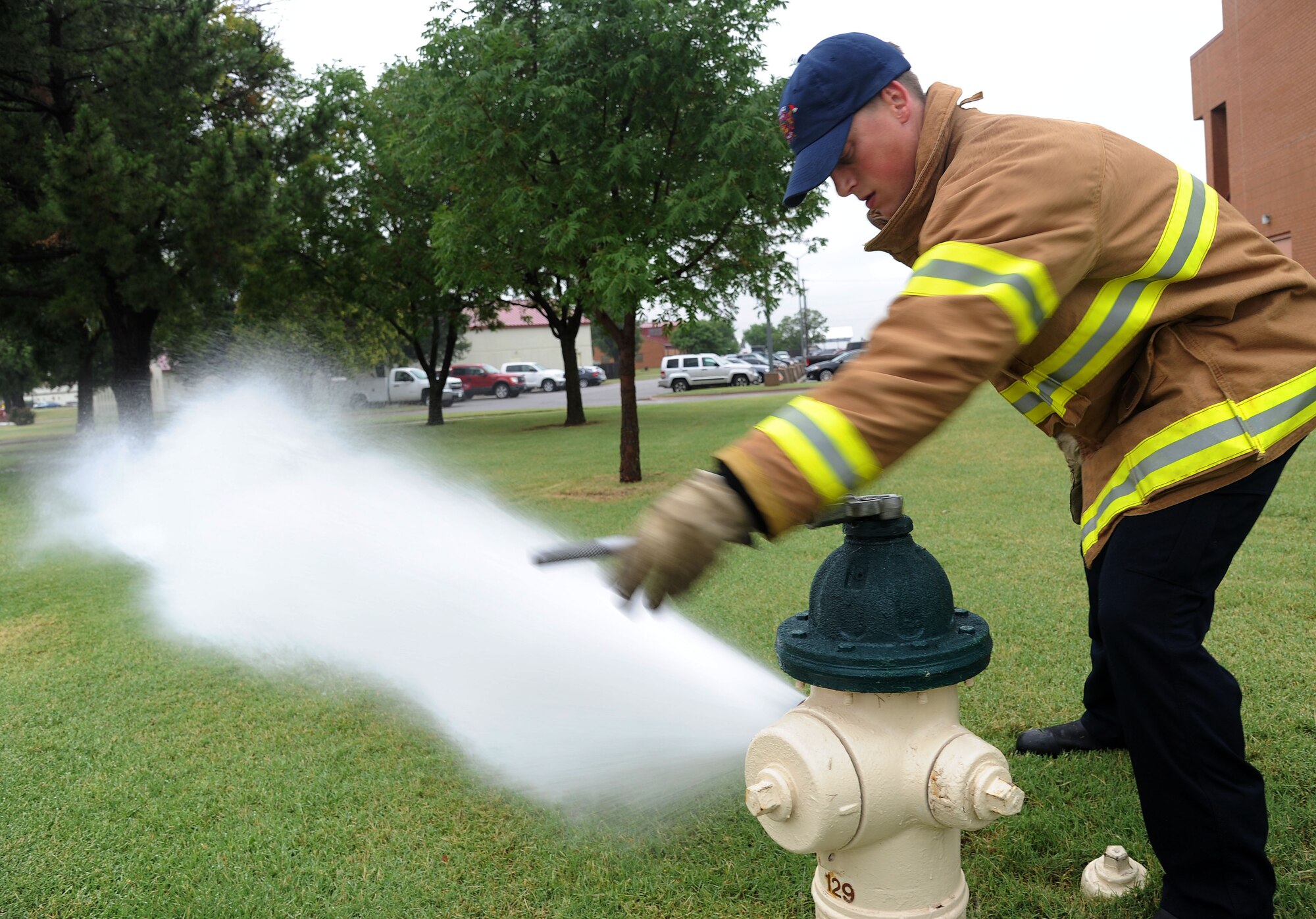 VANCE AIR FORCE BASE, Okla. -- Ryan Swaim, Vance Fire Department driver operator, tests the water availability supply and functionality of a fire hydrant at here July 17. The fire department conducts an annual test of all the fire hydrants on base.  (U.S. Air Force photo/Staff Sgt.  Nancy Falcon/RELEASED)