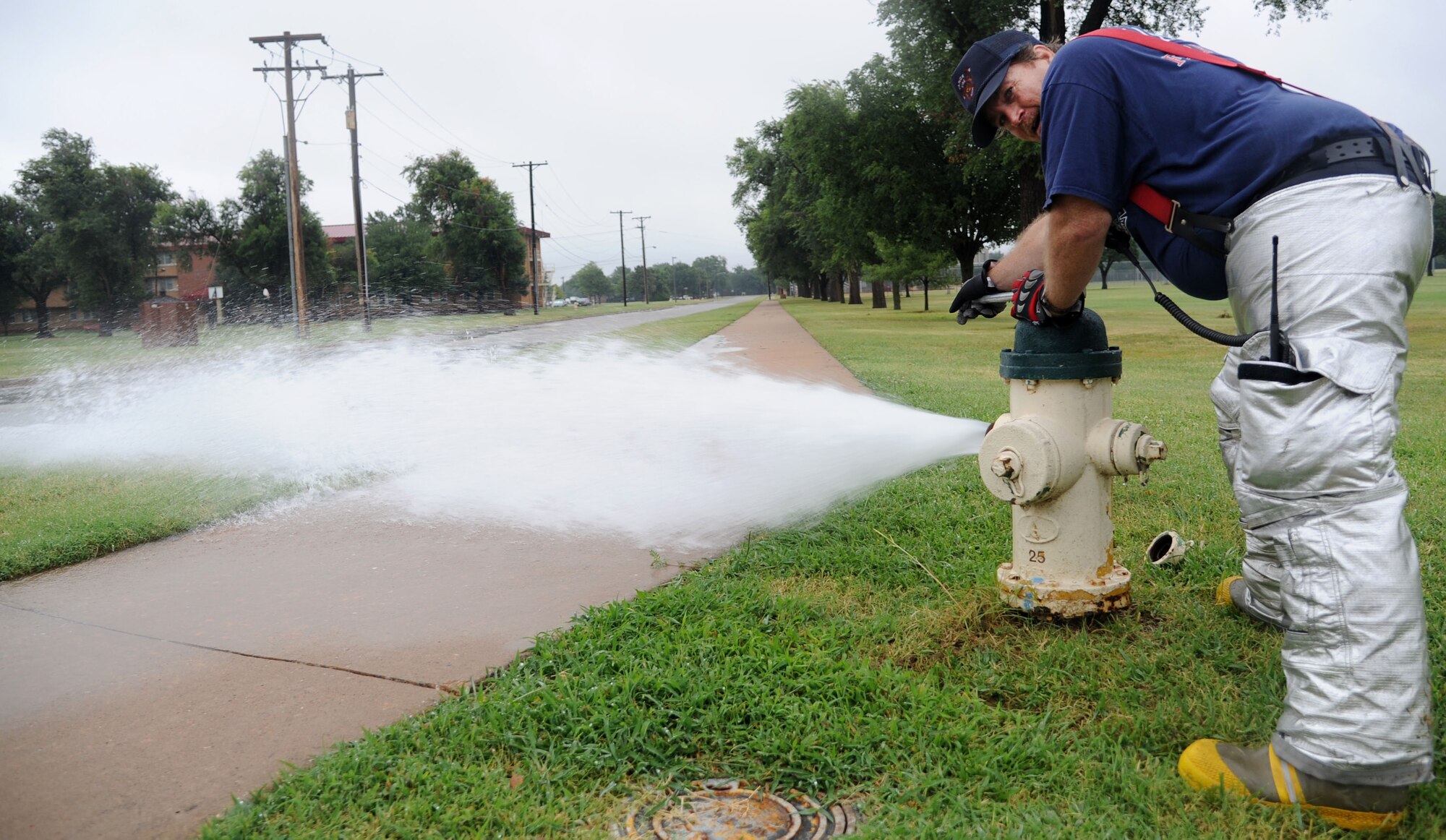 VANCE AIR FORCE BASE, Okla. -- Don Kirkley, a Vance Fire Department lead firefighter, tests the water availability supply and functionality of a fire hydrant at here July 17.  The fire department conducts an annual test of all the fire hydrants on base.  (U.S. Air Force photo/Staff Sgt. Nancy Falcon/RELEASED)