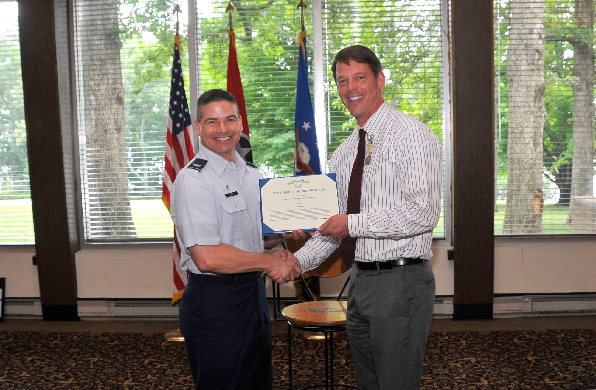 Col. Raymond Toth, AEDC commander, presents Dr. Doug Blake with a certificate recognizing his time spent serving as AEDC’s executive director.  (Photo by Jacqueline Cowan)