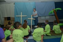 Julia Parris, drama instructor, tells biblical stories with props for students during vacation bible school  June 26 at Joint Base San Antonio-Randolph. (U.S. Air Force photo by Joel Martinez/Released)