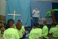 Julia Parris, drama instructor, tells biblical stories with props for students during vacation bible school  June 26 at Joint Base San Antonio-Randolph. (U.S. Air Force photo by Joel Martinez/Released)