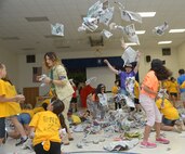 Danelle Blair, youth director and Technical Sgt. Kevin Dilley, 502nd Air Base Wing, Joint Base San Antonio-Lackland, play with students during vacation bible school June 26 at Joint Base San Antonio-Randolph. (U.S. Air Force photo by Joel Martinez/Released)