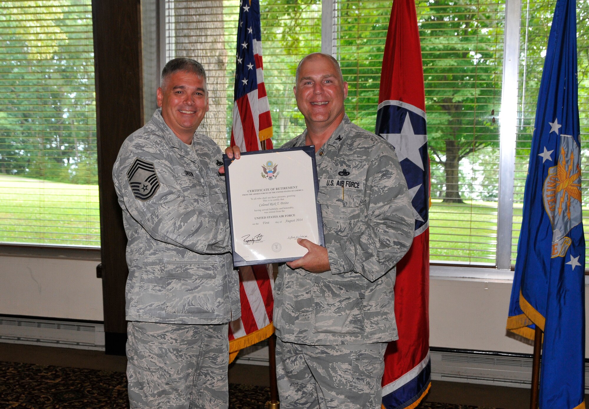 Air Force retiree Col. Rick Petito, a former AEDC Test Systems Sustainment Division Chief, accepts his Certificate of Retirement from retiring official Chief Master Sgt. Danny Green during a retirement ceremony June 27. Green is from the Air Force Research Laboratory, Wright Patterson Air Force Base, Ohio. (Photo by Jacqueline Cowan)