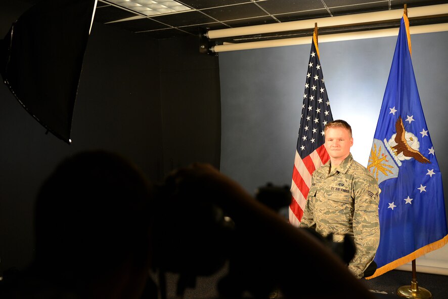 U.S. Air Force Senior Airman Quest Largent, 20th Fighter Wing nonjudicial punishment paralegal, has his official photo taken at Shaw Air Force Base, S.C., July 17, 2014. Public Affairs photojournalists take head and shoulders official photos, full length photos and passport photos for all Airmen on base. (U.S. Air Force photo by Airman 1st Class Diana M. Cossaboom/Released)