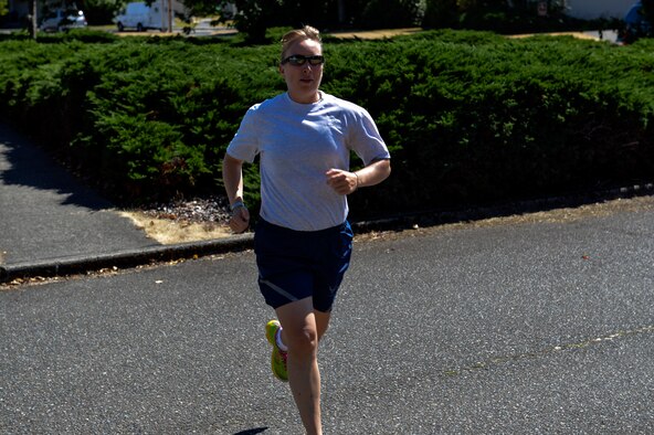 Capt. Amanda Turcotte, 627th Force Support Squadron sustainment flight commander, runs a route July 16, 2014, from the fitness track to the Aerial Port Squadron at Joint Base Lewis-McChord, Wash. Turcotte has scored a 100 percent on every Air Force fitness test she has taken since ROTC and holds the fastest female run time of all Airmen at JBLM with a 9:23 mile and a half. (U.S. Air Force photo/Staff Sgt. Russ Jackson)