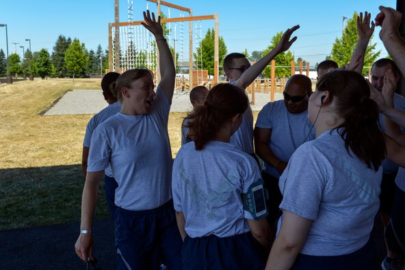 Capt. Amanda Turcotte, 627th Force Support Squadron sustainment flight commander, rallies her Airmen before a run July 16, 2014, from the fitness track to the Aerial Port Squadron and back at Joint Base Lewis-McChord, Wash. After doctors discovered blood clots in her lungs and knee, a medical evaluation board at Lackand Air Force Base, Texas tried to separate her but she proved to them she was fit for duty. (U.S. Air Force photo/Staff Sgt. Russ Jackson)