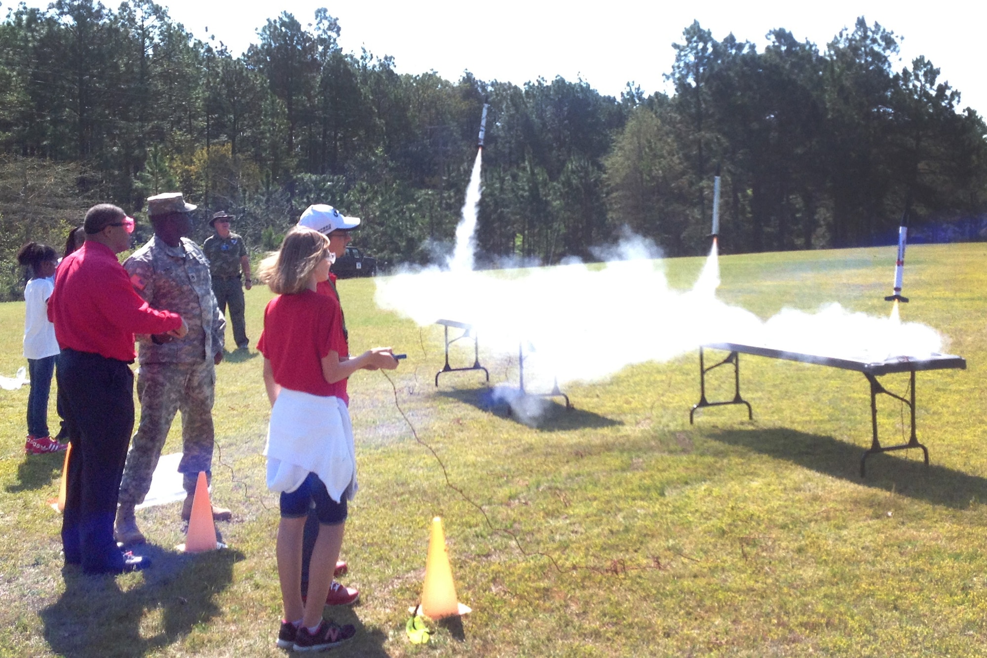 Senior Airman Manley McKinley (uniform, center), from the 169th Aircraft Maintenance Squadron, lends a hand during the model rocket launch phase of STARBASE’s summer camp help at McEntire JNGB in June. (Photo courtesy of Mrs. Beth Barkley, STARBASE Swamp Fox)