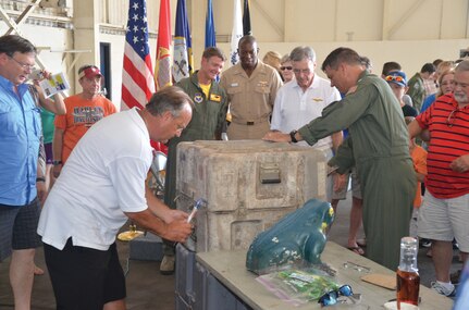 The HC-16 Bullfrogs’ time capsule is opened inside a hangar at NASP’s Forrest Sherman Field July 11. Squadron memorabilia from two decades ago was examined and will be re-interred with mementos of today. (Photo by Mike O’Connor)