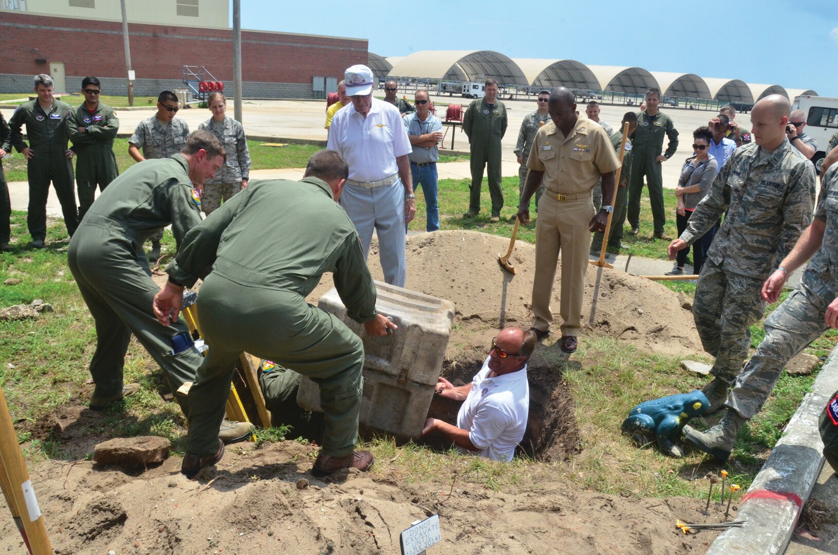 From left) Col. Thomas Shank, commanding officer of the 479th Flying Training Group (FTG), Navy Capt. Mike Fisher, retired Lt. Cmdr. Lee Wright, retired Navy Capt. Dan Hansen and NASP CO Capt. Keith Hoskins excavate a time capsule placed 20 years ago by search and rescue helicopter squadron HC-16. (Photo by Mike O’Connor)