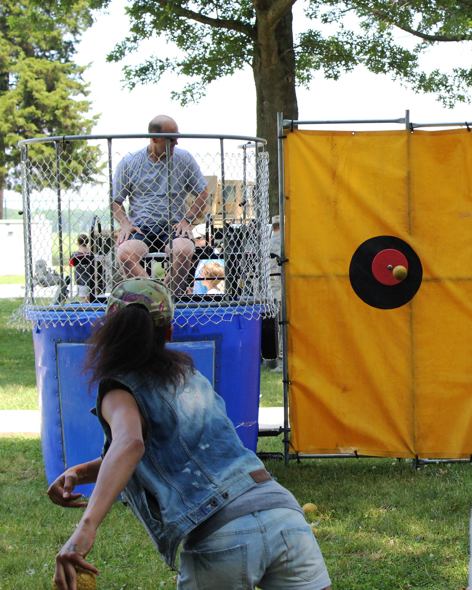 Col. Raymond A. Kozak, 512th Airlift Wing commander, eyes the target before a wing family member hit the bull's eye sending him under water at the 512th Airlift Wing's Wingman Day Picnic July 12, 2014, at Dover Air Force Base, Del. Other activities at the event included games of corn hole, horse shoes and volleyball. (U.S. Air Force photo/Staff Sgt. Mercedes Crossland)
