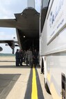 Air Force and Navy members work together to transfer simulated victims from a C-130 Hercules aircraft to a Veterans Affairs medical center bus, during a National Disaster Medical System Exercise at the Pittsburgh International Airport Air Reserve Station, July 12, 2014. (U.S. Air Force photo by Staff Sgt. Jonathan Hehnly)