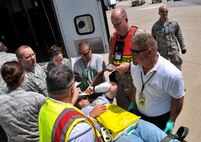 Participants of Lycoming Reach, a National Disaster Medical System exercise, transport a simulated patient from a bus to the triage area, July 12, 2014 at the Pittsburgh IAP ARS, Pa. (U.S. Air Force photo by Senior Airman Joshua J. Seybert)