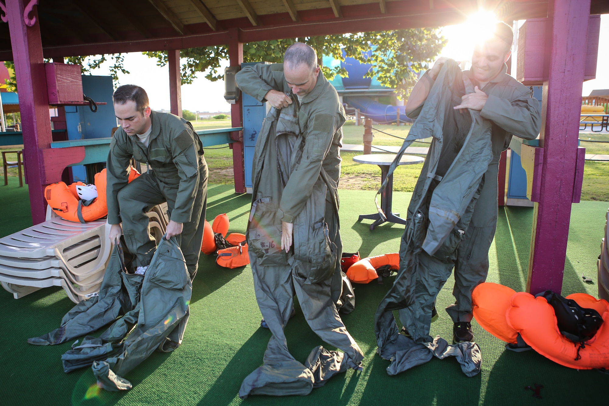 Reservists from the 970th Airborne Air Control Squadron practice putting on anti-exposure suits during water survival training July 13 at White Water Bay in Oklahoma City. The Airmen are required to complete the training every few years to make sure they are prepared for in-flight emergencies. (U.S. Air Force photo/Staff Sgt. Caleb Wanzer)