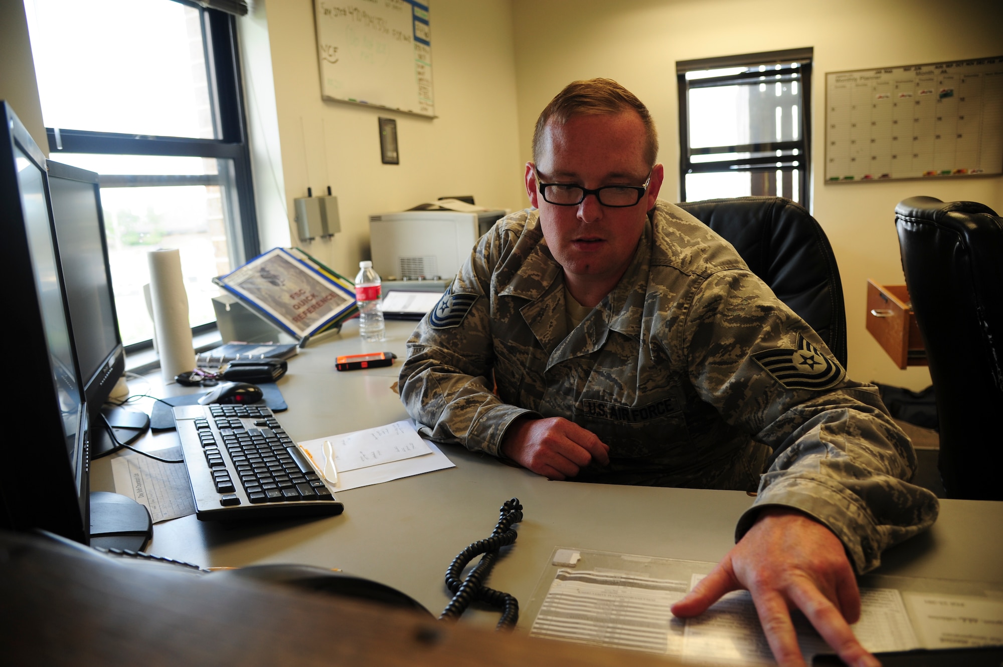 Tech. Sgt. Scott Roe, a 19th Logistics Readiness Squadron fuels management flight noncommissioned officer in charge of the fuels service center, receives a fuel request July 10, 2014, at Little Rock Air Force Base, Ark. Jet fuel servicing requests are called in to the fuels service center from either the maintenance operations center or transient alert. (U.S. Air Force photo by Senior Airman Kaylee Clark)