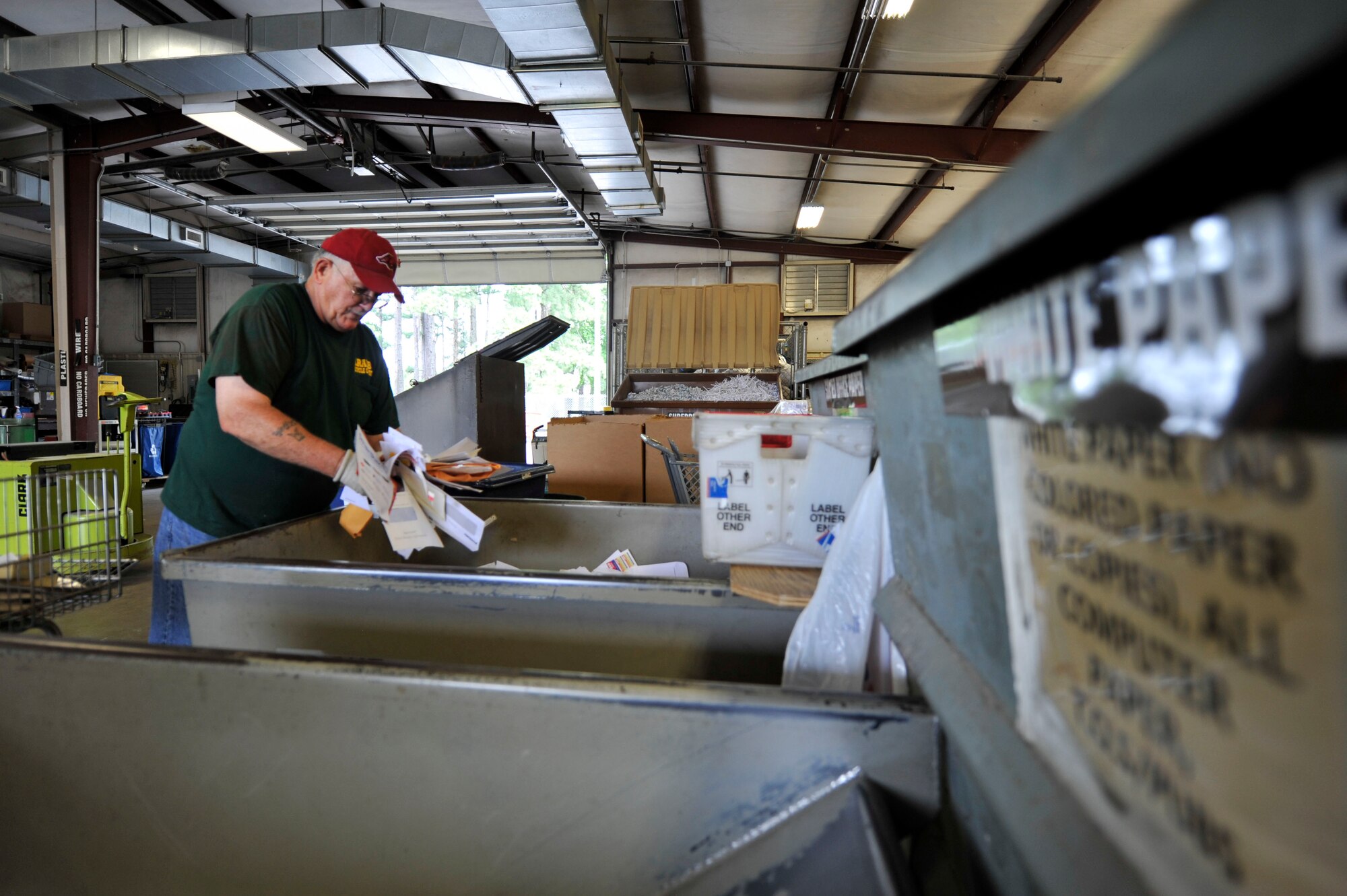 Wally Barron, Little Rock Air Force Base Recycling Center warehouse manager, sorts through white and colored paper July 8 2014, at Little Rock Air Force Base. Team Little Rock recycled approximately 2 million pounds of items last year. (U.S. Air Force photo by Senior Airman Regina Agoha)