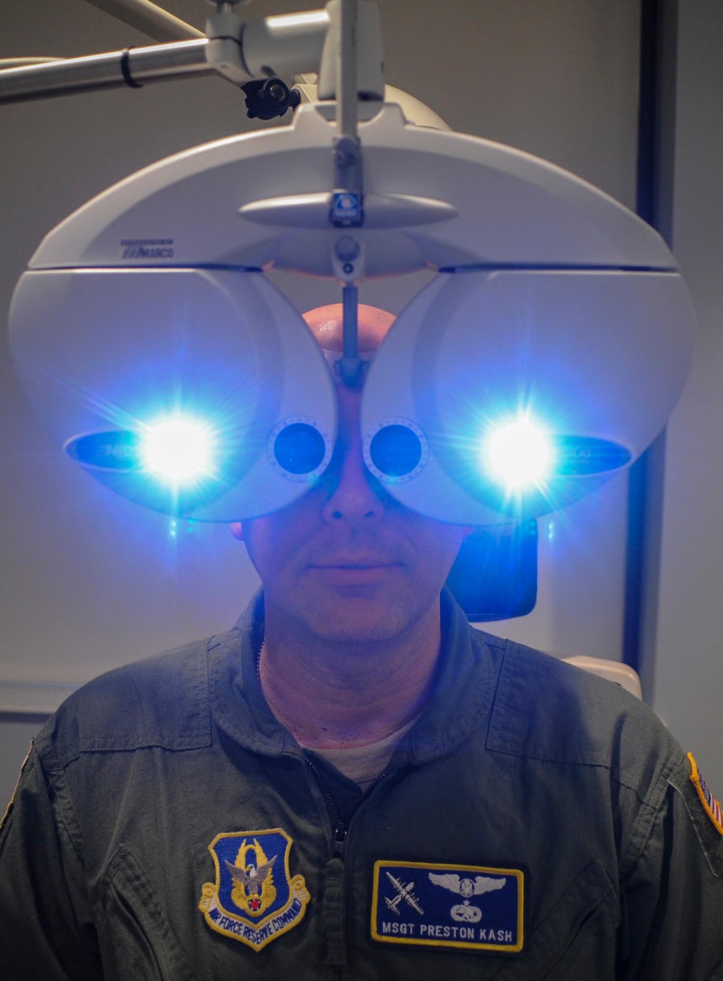 Master Sgt. Preston Kash, a 22nd Air Force Detachment 1 flight engineer, has his vision capability tested with a phoropter during an eye examination June 30, 2014, at Little Rock Air Force Base, Ark. Examples of things evaluated during a routine eye exam include eye pressure, depth perception, eye muscle movement and the condition of the retinas. (U.S. Air Force photo by Airman 1st Class Harry Brexel)