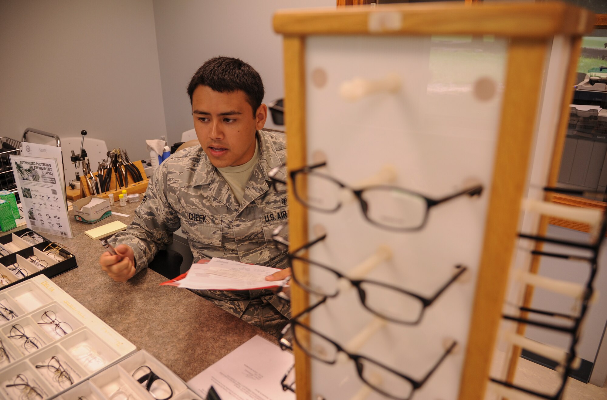 Airman 1st Class Eli Cheek, a 19th Aerospace Medicine Squadron optometry technician, discusses frame options with a patient June 30, 2014, at Little Rock Air Force Base, Ark. Providing glasses is just one of the many services that the optometry clinic offers. (U.S. Air Force photo by Airman 1st Class Harry Brexel)