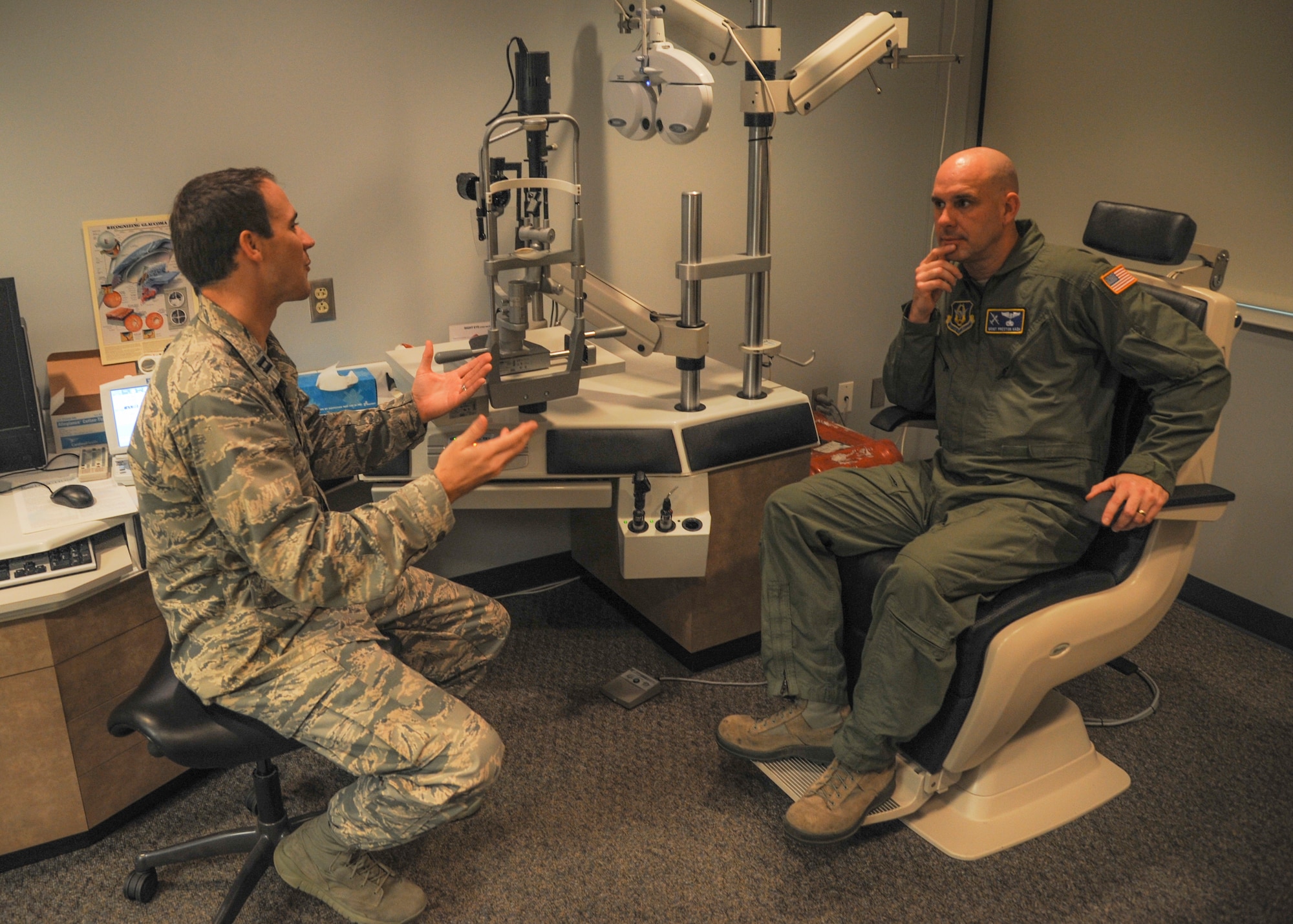 Capt. Cody Peterson, a 19th Aerospace Medicine Squadron optometrist, explains the importance of wearing glasses to Master Sgt. Preston Kash, a 22nd Air Force Det. 1 flight engineer, June 30, 2014, at Little Rock Air Force Base, Ark. Peterson and his team perform up to 140 eye examinations each week. (U.S. Air Force photo by Airman 1st Class Harry Brexel)