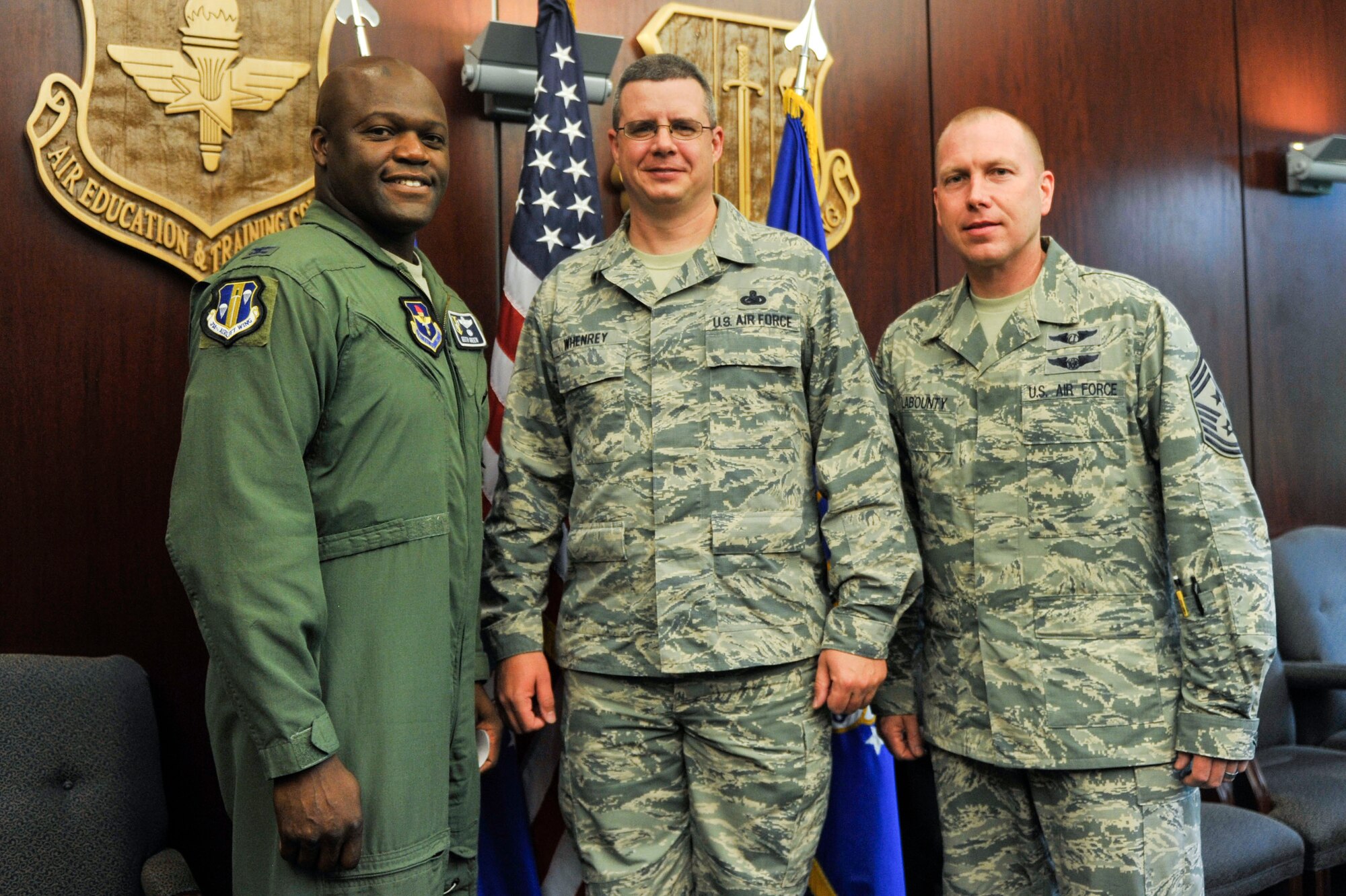 Col. Keith Green, 314th Airlift Wing vice commander, and Chief Master Sgt. Brian LaBounty, 314th AW command chief, congratulate Senior Master Sgt. Larry Whenrey, the 314th AW Inspector General inspections superintendent, for his selection as Combat Airlifter of the Week July 14, 2014, at Little Rock Air Force Base, Ark. Whenrey assumed the duties of the 314th AW management internal control toolset and self-assessment program manager, developed the MICT business rules and trained the wing in MICT. (U.S. Air Force photo by Senior Airman Regina Agoha)