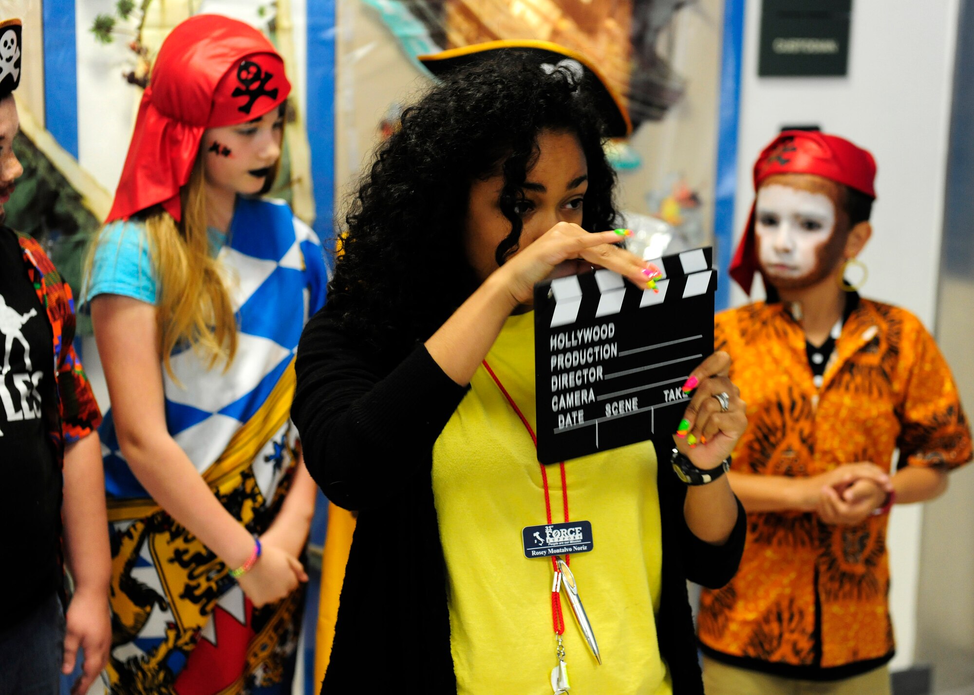 Rosanna Montalvo Noriz, 31st Force Support Squadron Aviano Youth Programs assistant, snaps a clapperboard during theater camp, July 16, 2014, at Aviano Air Base, Italy. The AYP’s summer camps run throughout the rest of the school break and offer other sports and activities camps weekly. (U.S. Air Force photo/Airman 1st Class Ryan Conroy) 