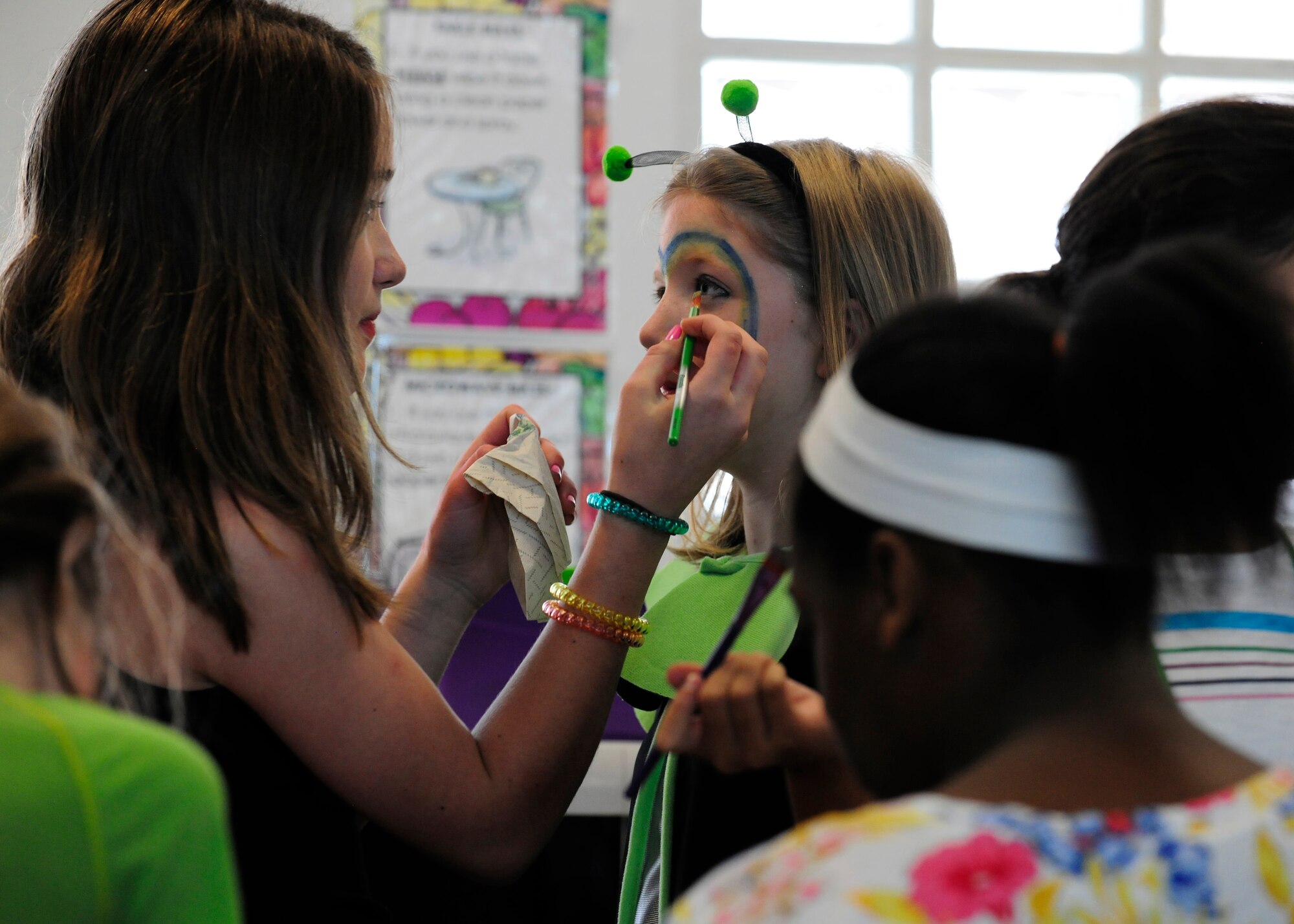 Skyler Wyrembelski gets her face painted before a theater performance, July 16, 2014, at Aviano Air Base, Italy. In addition to activity camps offered by the Aviano Youth Programs, such as theater, parents can enroll their children in sports camp programs as well. Wyrembelski is currently attending AYP’s summer camp. (U.S. Air Force photo/Airman 1st Class Ryan Conroy) 