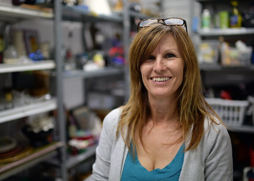 Caroline Pritchert, Airman's Attic coordinator, smiles for a photo July 15, 2014, at Spangdahlem Air Base, Germany. The Attic is sponsored by the 52nd Force Support Squadron's Airman and Family Readiness Center, and Pritchert oversees the daily operations of the facility. (U.S. Air Force photo by Staff Sgt. Daryl Knee/Released)