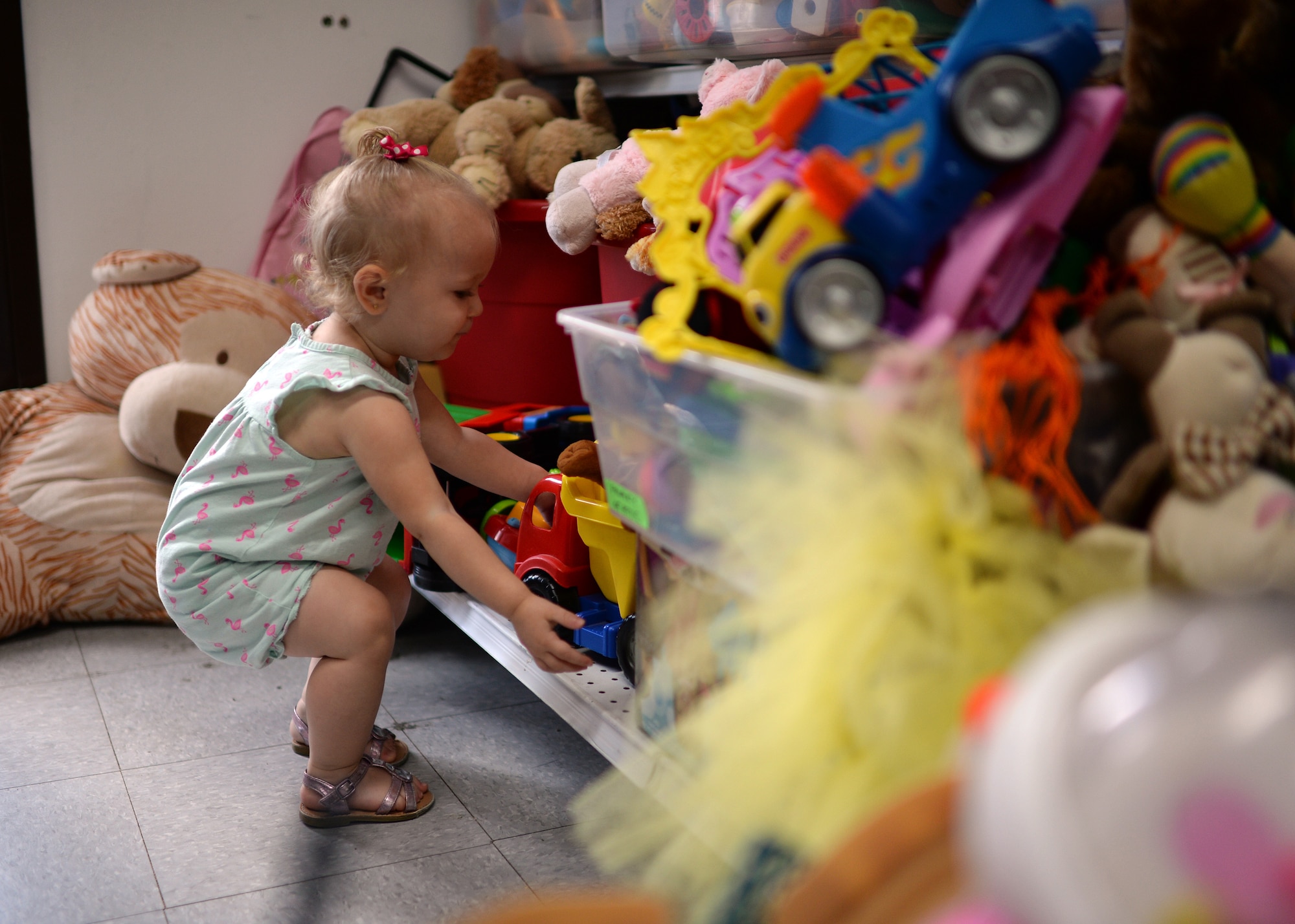 Loralei, daughter of U.S. Air Force Staff Sgt. Justin Blakeman, 52nd Component Maintenance Squadron and native of Gonzales, La., selects a toy July 15, 2014, from the children section of the Airman's Attic at Spangdahlem Air Base, Germany. The Attic collects donations from base members and redistributes them at no cost to service members. However, a recent influx of donations to the Attic has forced the staff to recycle nearly 1,000 pounds of toys, dishware, electronics and books a month. (U.S. Air Force photo by Staff Sgt. Daryl Knee/Released)