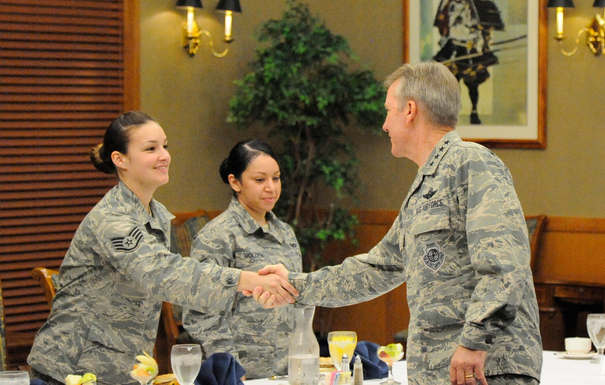 Pacific Air Forces Commander, Gen. Hawk Carlisle, shakes hands with Staff Sgt. Erin Smith, 35th Medical Group aerospace medical technician, during a breakfast at Misawa Air Base, Japan, July 15, 2014. During the breakfast, Carlisle discussed the importance and responsibility of supervising Airmen and their current role in the Air Force with staff sergeants and technical sergeants. (U.S. Air Force photo/Airman 1st Class Patrick S. Ciccarone)