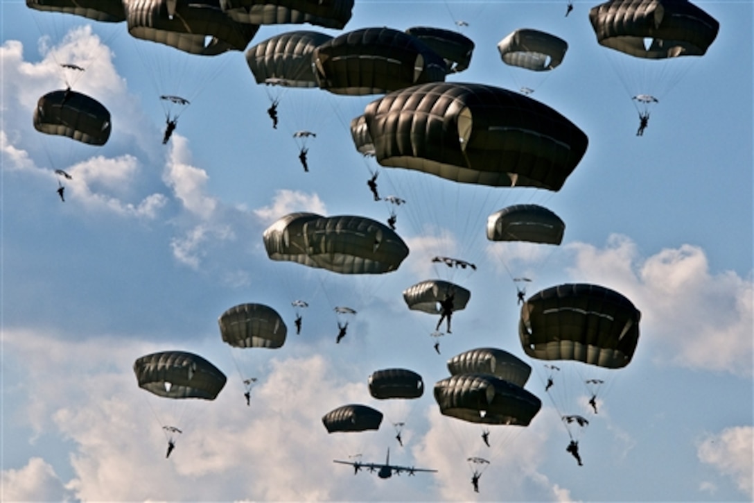 U.S. paratroopers conduct an airborne operation in Nurmsi, Estonia, July 8, 2014. About 600 paratroopers from the brigade are in Estonia, Latvia, Lithuania and Poland as part of Operation Atlantic Resolve to demonstrate commitment to NATO obligations and sustain interoperability with allied forces. The paratroopers are assigned to 1st Squadron, 91st Cavalry Regiment, 173rd Airborne Brigade. 