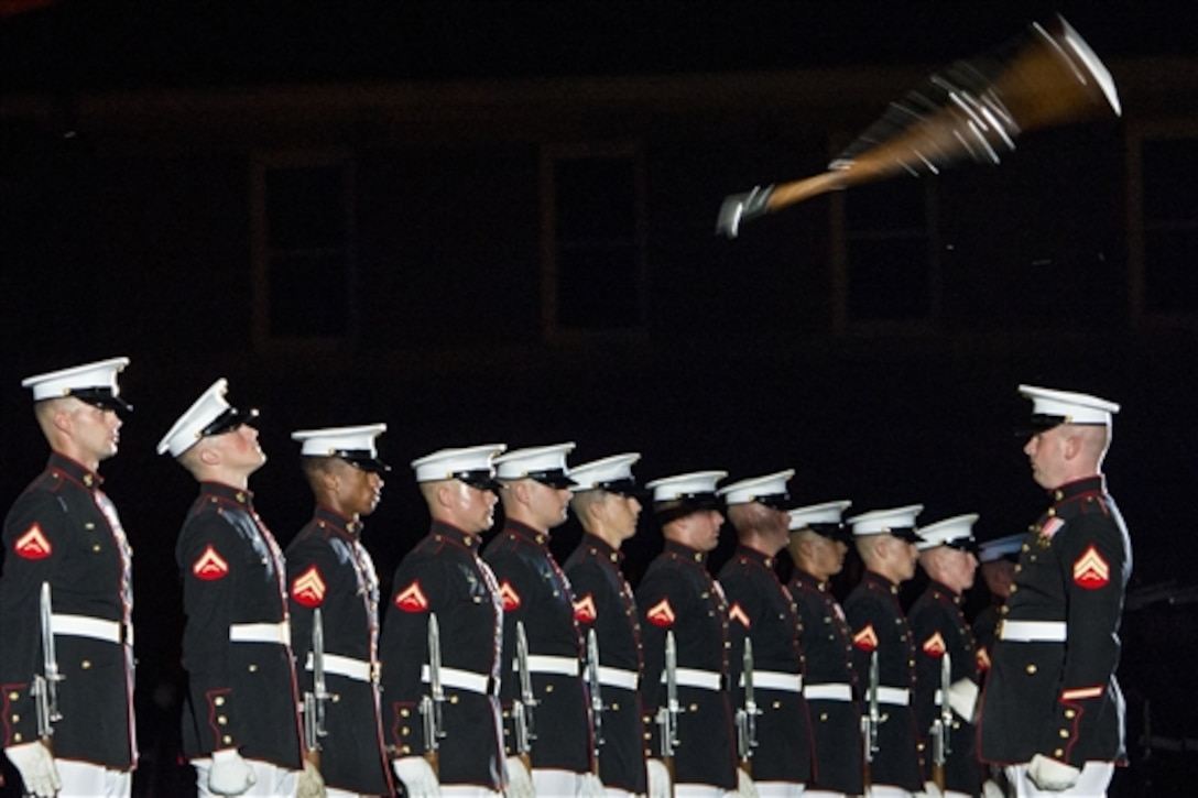 Members of the Marine Corps Silent Drill Platoon perform during the evening parade to honor Navy Adm. James A. Winnefeld Jr., vice chairman of the Joint Chiefs of Staff, at Marine Barracks Washington, D.C., July 11, 2014. The parade also included the U.S. Marine Band, known as "The President's Own," The U.S. Marine Drum and Bugle Corps, the Marine Corps Color Guard, and Lance Cpl. Chesty XIII, the official mascot of the Marine post. 