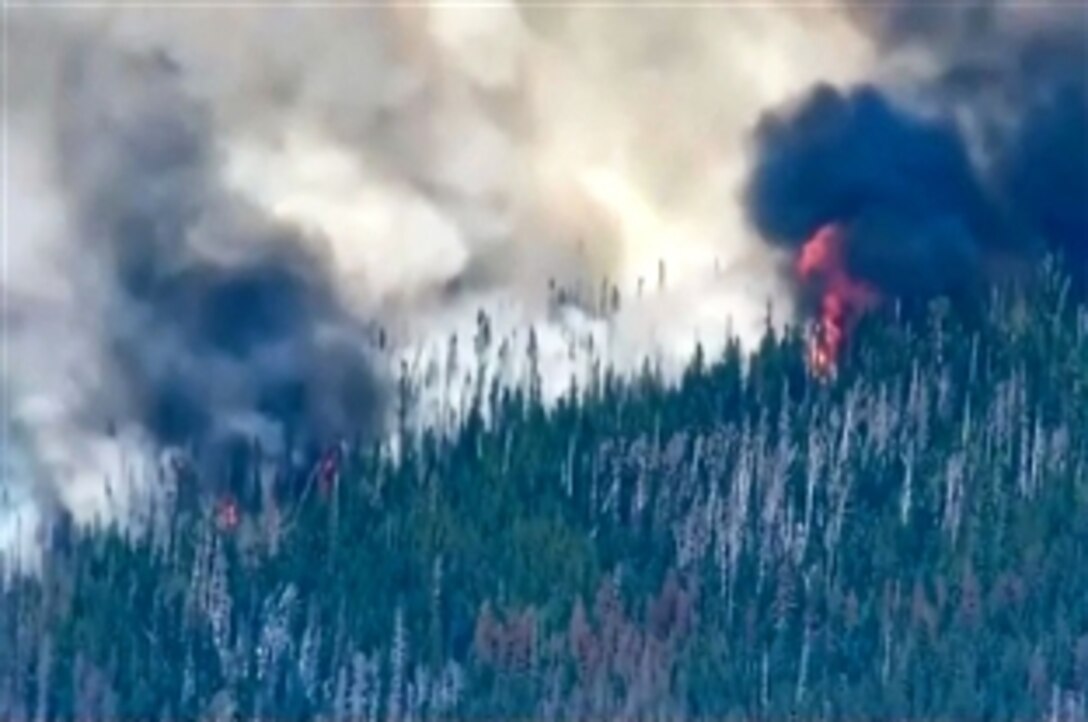 Two helicopters and about a dozen Washington State National Guardsmen are supporting civilian response to wildfires in the state. The fires have threatened hundreds of homes.
