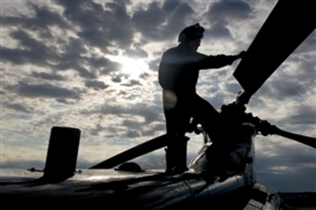 Marine  Corps Sgt. Mario A. Ramirez performs the last preflight check on a CH-46E Sea Knight on Marine Corps Air Facility Quantico, Va., July 16, 2014. Shortly after Ramirez completed his check, the last four Sea Knights departed the squadron for the last time. Ramirez is an air frames mechanic assigned to Marine Corps Helicopter Squadron One, Headquarters Marine Corps.