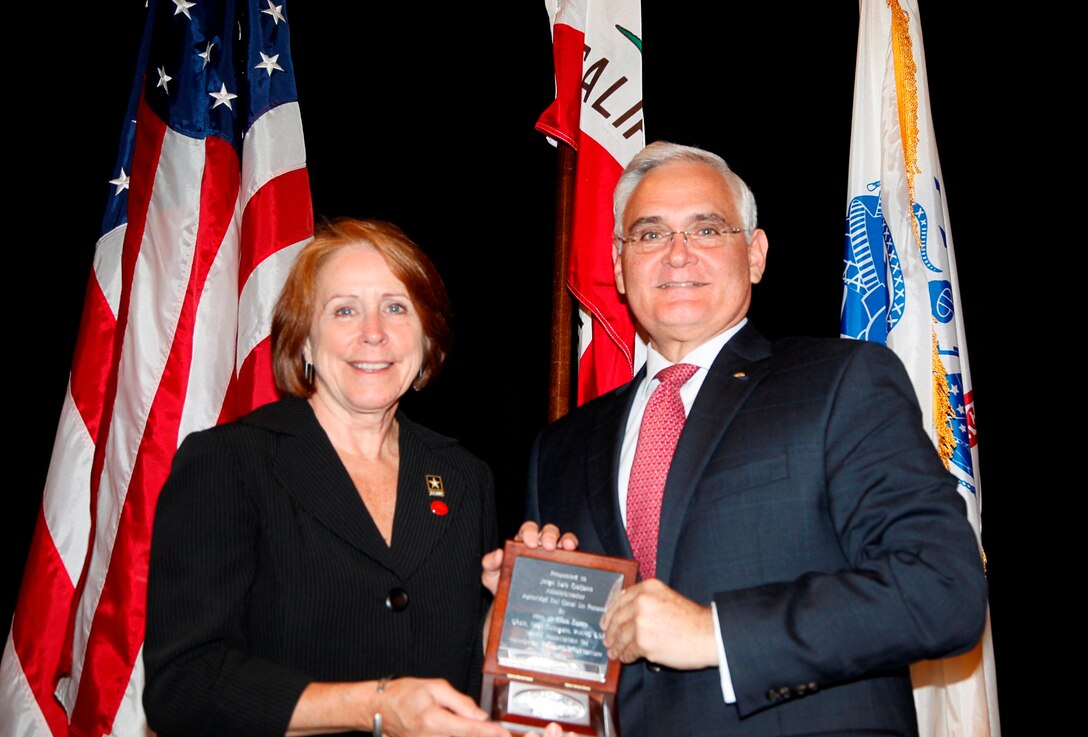 The Honorable Jo-Ellen Darcy, Assistant Secretary of the Army (Civil Works) & Chair of PIANC USA, presents Mr. Jorge Quijano, Administrator, Panama Canal Authority, with a gift of thanks for his keynote speech.