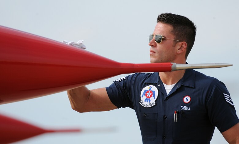 Staff Sgt. Christopher Collins wipes down his aircraft during post-flight inspections following a performance at Battle Creek Field of Flight Air Show and Balloon Festival July 5, 2014, in Battle Creek, Mich. Collins is the Thunderbird 6 dedicated crew chief. (U.S. Air Force photo/Master Sgt. Stan Parker)