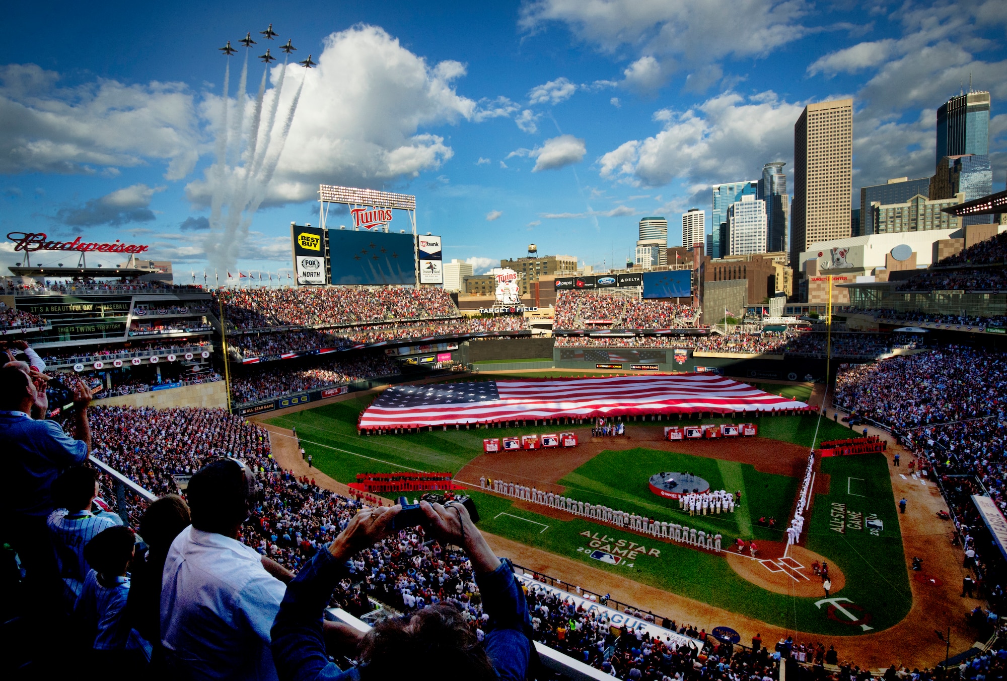 The Thunderbirds perform a flyover during the national anthem at the Major League Baseball’s All-Star Game July 15, 2014, in Minneapolis, Minn. The Thunderbirds are the Air Force’s precision flying demonstration team that flies red, white and blue F-16 Fighting Falcons (U.S. Air Force photo/Master Sgt. Stan Parker)