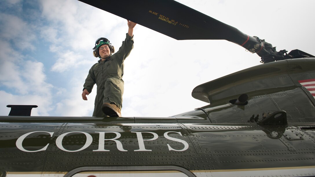 Sgt. Mario A. Ramirez, an air frames mechanic with Marine Corps Helicopter Squadron One, Headquarters Marine Corps, smiles while performing his last preflight check on a CH-46E Sea Knight on Marine Corps Air Facility Quantico July 16, 2014.  (U.S. Marine Corps photo by Cpl. Terry Brady/Released)