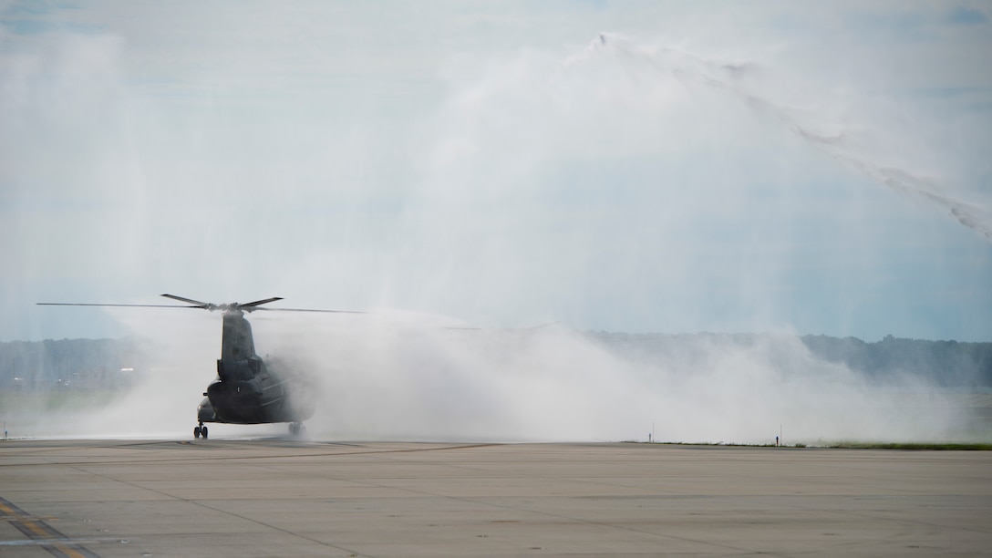 A CH-46E Sea Knight taxis through the streams of two fire engines on Marine Corps Air Facility Quantico July 16, 2014. It is customary among squadrons to douse an aircraft before it’s final flight with the squadron. (U.S. Marine Corps photo by Cpl. Terry Brady/Released)