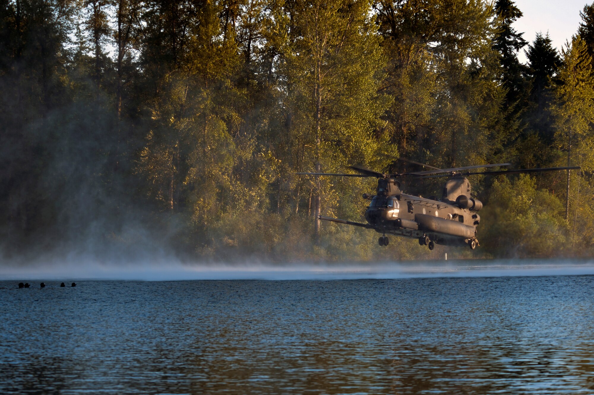 Airmen from the 22nd Special Tactics Squadron’s Red Team wait in American Lake, for an MH-47 Chinook helicopter to extract them during helocast alternate insertion and extraction training July 14, 2014, at Joint Base Lewis-McChord, Wash. The Soldiers, with the 160th Special Operations Aviation Regiment, needed the alternate insertion and extraction training and called upon members of the 22nd STS for assistance. (U.S. Air Force photo/Staff Sgt. Russ Jackson)