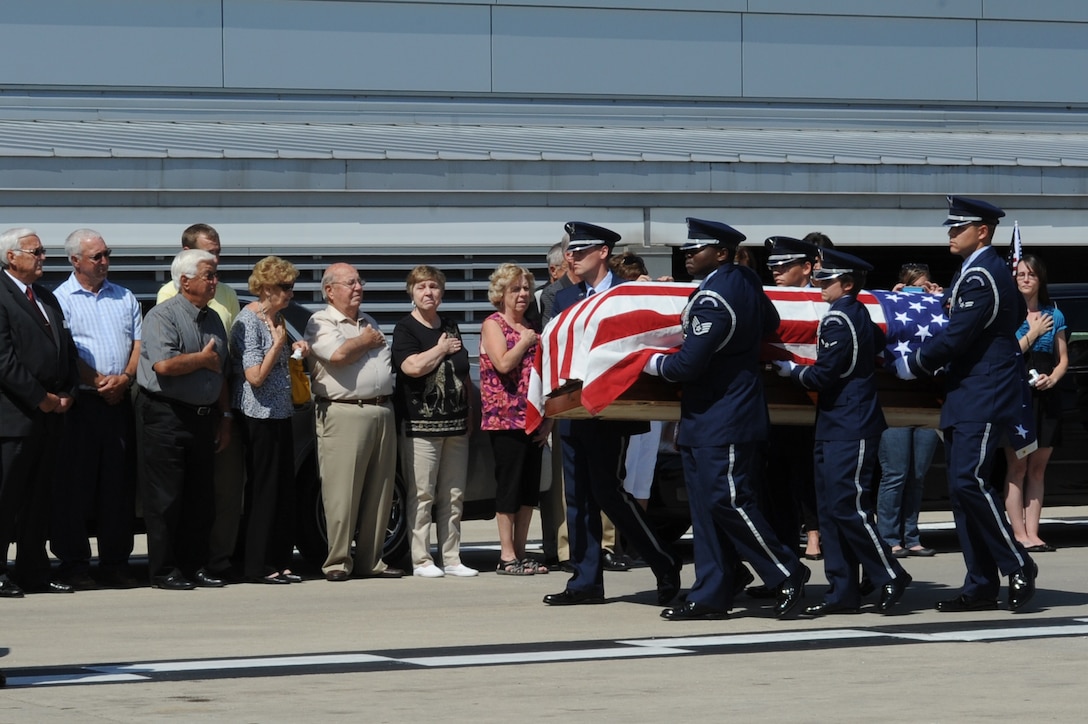 Members of the Scott Air Force Base Honor Guard transport the remains of Airman 3rd Class Howard Martin during a dignified arrival July 10, 2014, at the Indianapolis International Airport, Indiana. Martin died during a C-124 crash in 1952 and his remains were recovered earlier in 2014. (U.S. Air Force photo/Senior Airman Sarah Hall-Kirchner)