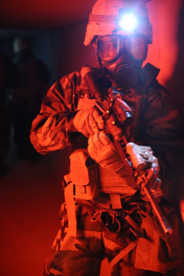 Lance Cpl. Armando Moreno, a chemical, biological, radiological and nuclear specialist with Headquarters and Service Company, 4th Light Armored Reconnaissance Battalion, walks toward a simulated weapons cache that includes sarin gas at the Army National Training Center Fort Irwin, California, July 12, 2014. The CBRN Marines used their equipment to test the area for contaminants in the air and ensure the simulated gas was contained.  This was part of 4th LAR’s annual training, which was the first time since the battalion’s deployment to Afghanistan in 2009 – 2010 that the companies within the battalion worked together.
