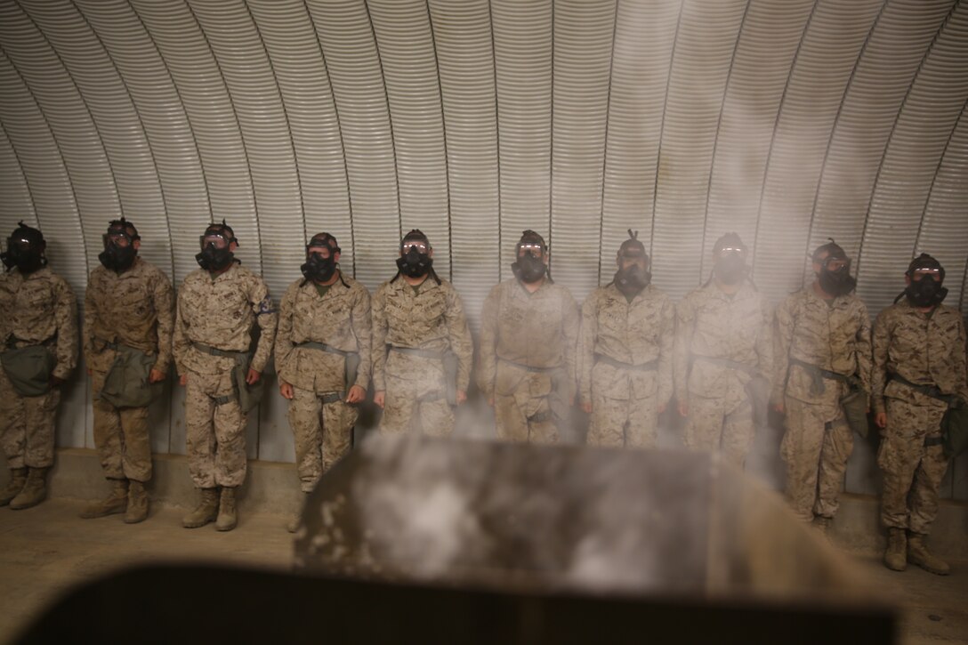 Recruits of India Company, 3rd Recruit Training Battalion, wait for the Confidence Chamber to fill was CS gas before conducting required exercises at Edson Range, aboard Marine Corps Base Camp Pendleton, July 14. This gas is a non-lethal tear gas and a riot control agent.